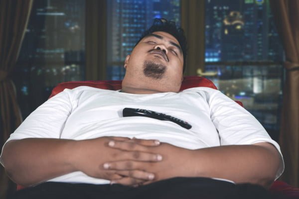 depositphotos 252794354 stock photo obese man sleeps with a