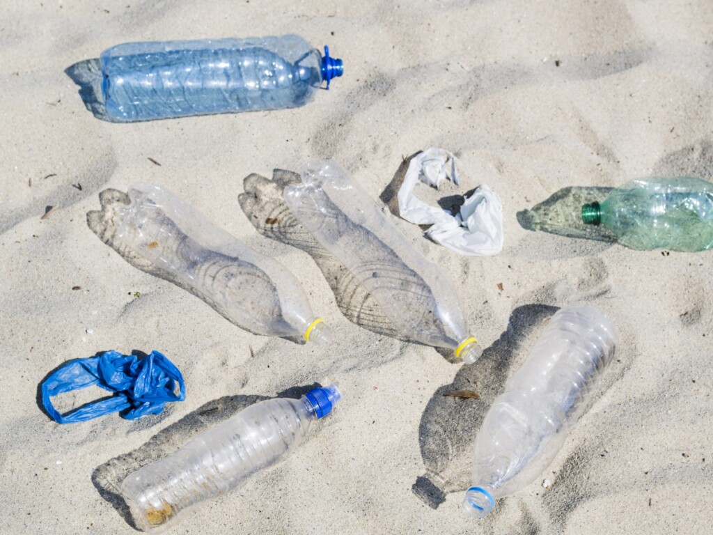 empty plastic water bottles plastic bag sand scaled