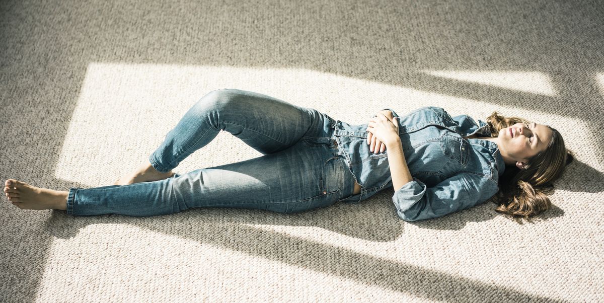 young woman lying on carpet in the living room royalty free image 909223234 1537891205