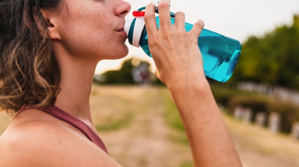 woman athlete drinking water exercising 1296x728 header